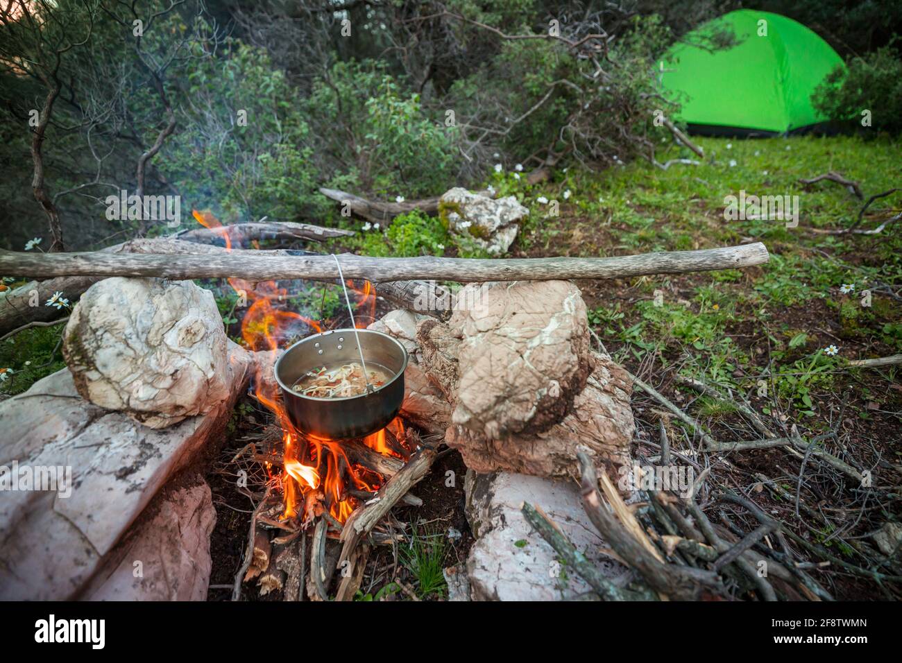 Touristic kettle on fire of burning campfire in camping in the hike ...