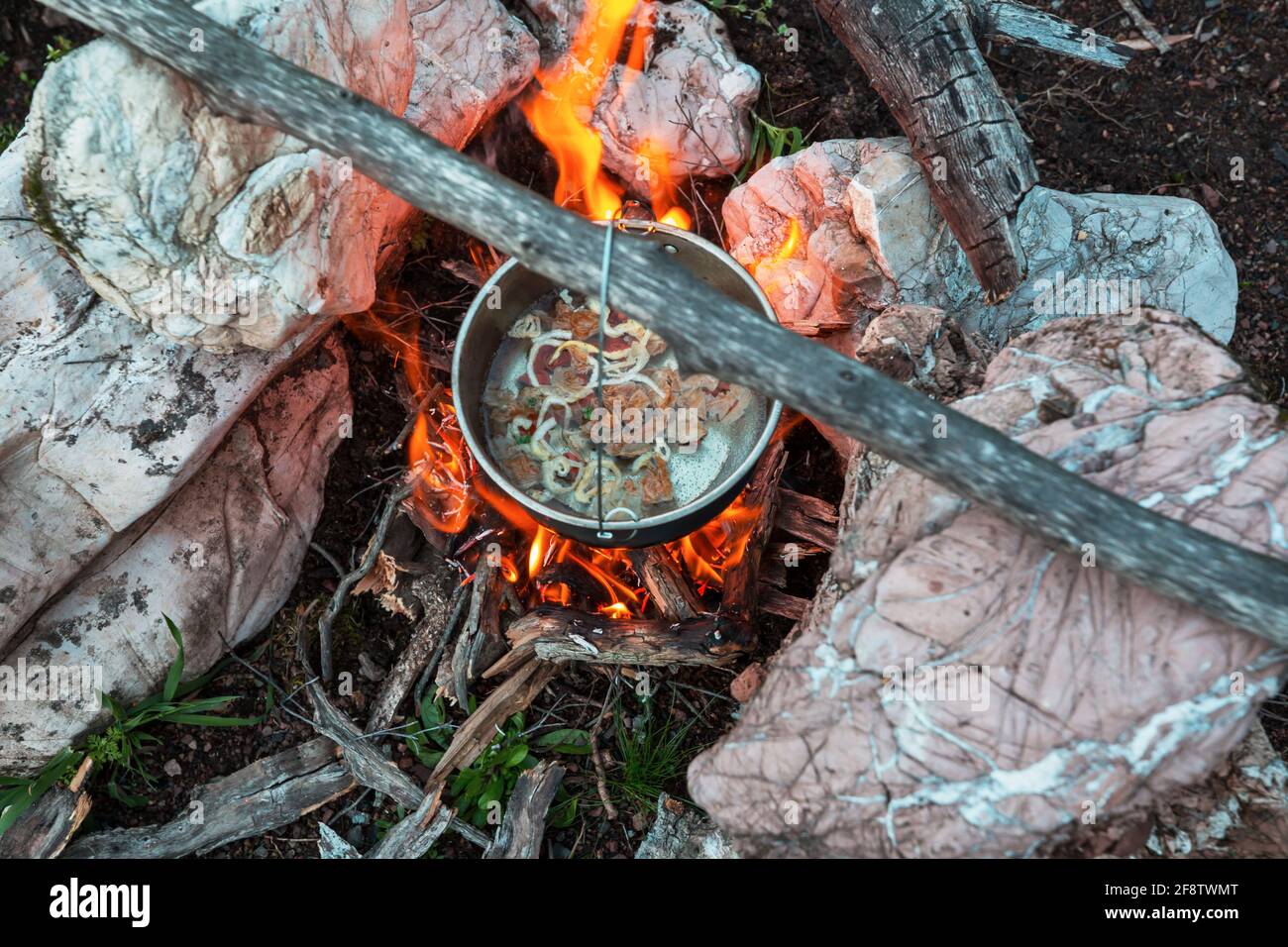 Touristic kettle on fire of burning campfire in camping in the hike ...