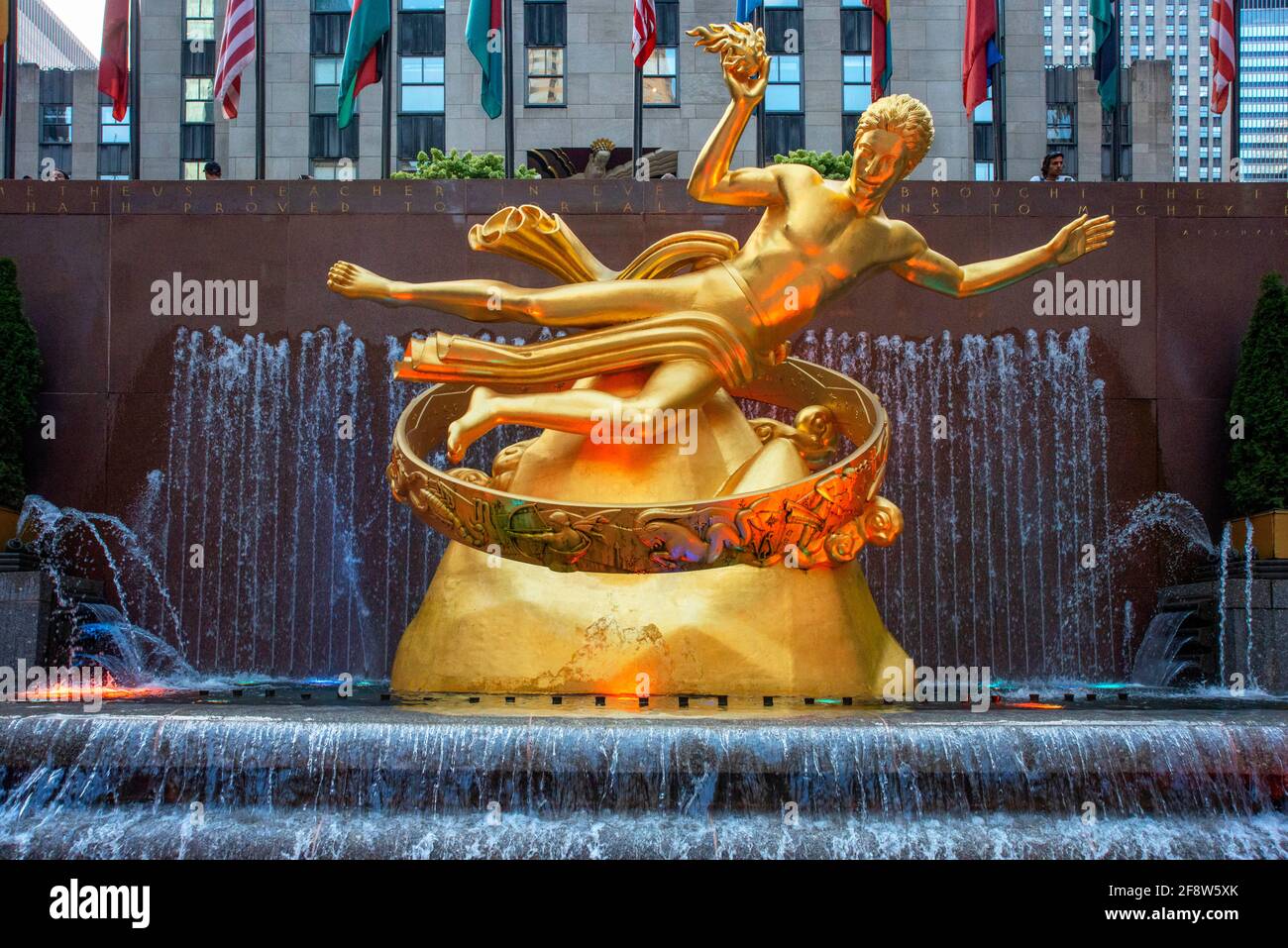 The statue of the Titan God, Prometheus sits above the sunken plaza at the Rockefeller Center located in Midtown Manhattan, NYC The rink at the Rockef Stock Photo