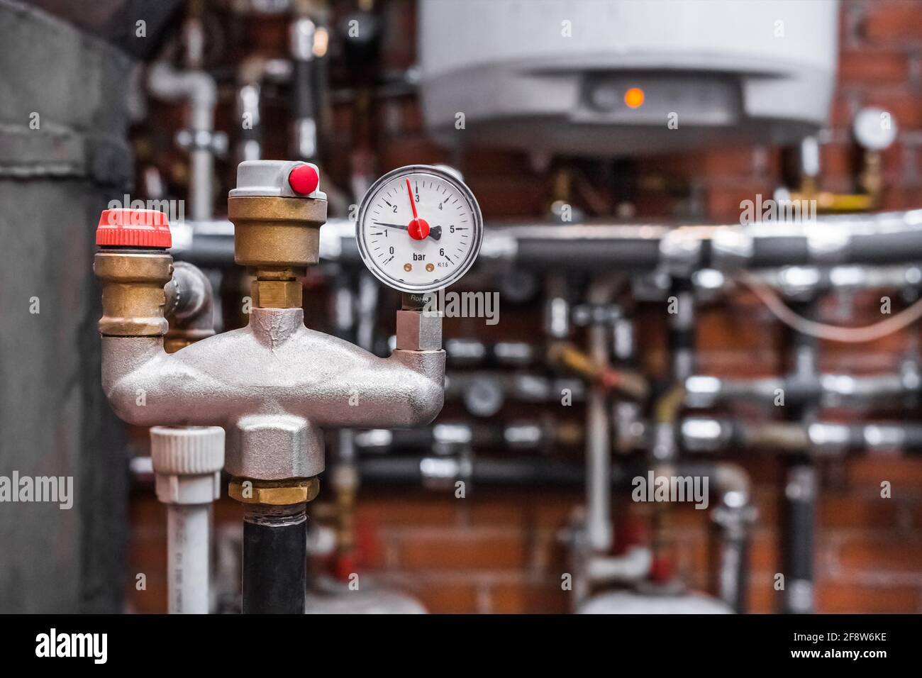 A pressure gauge with an automatic safety valve on the pipe against the ...