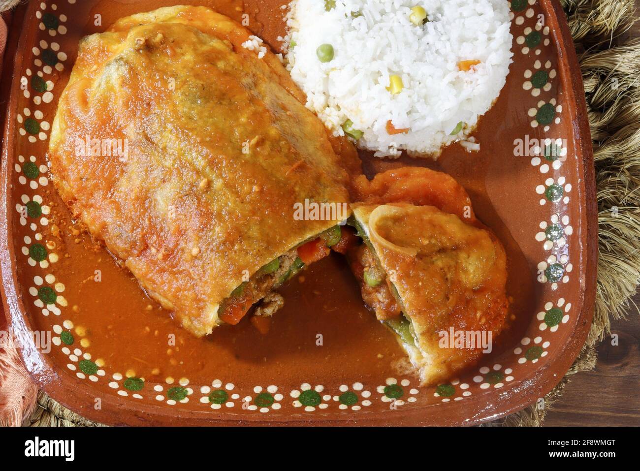 Mexican dish chile relleno with picadillo, tomato sauce, ground meat