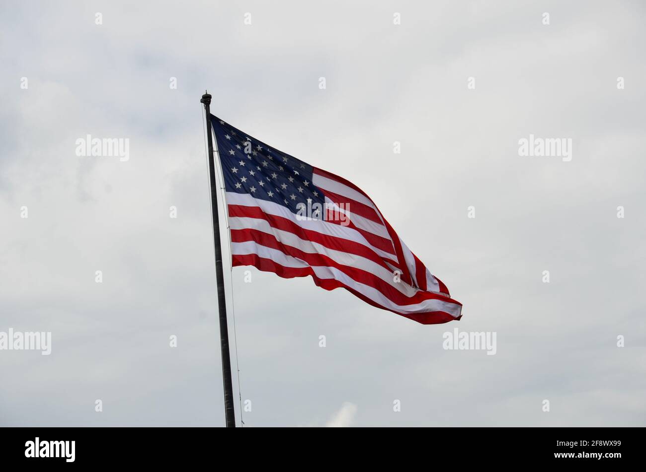 23. July 2013: New York, New York, USA: American flag blows in the wind in cloudy weather in New York Stock Photo