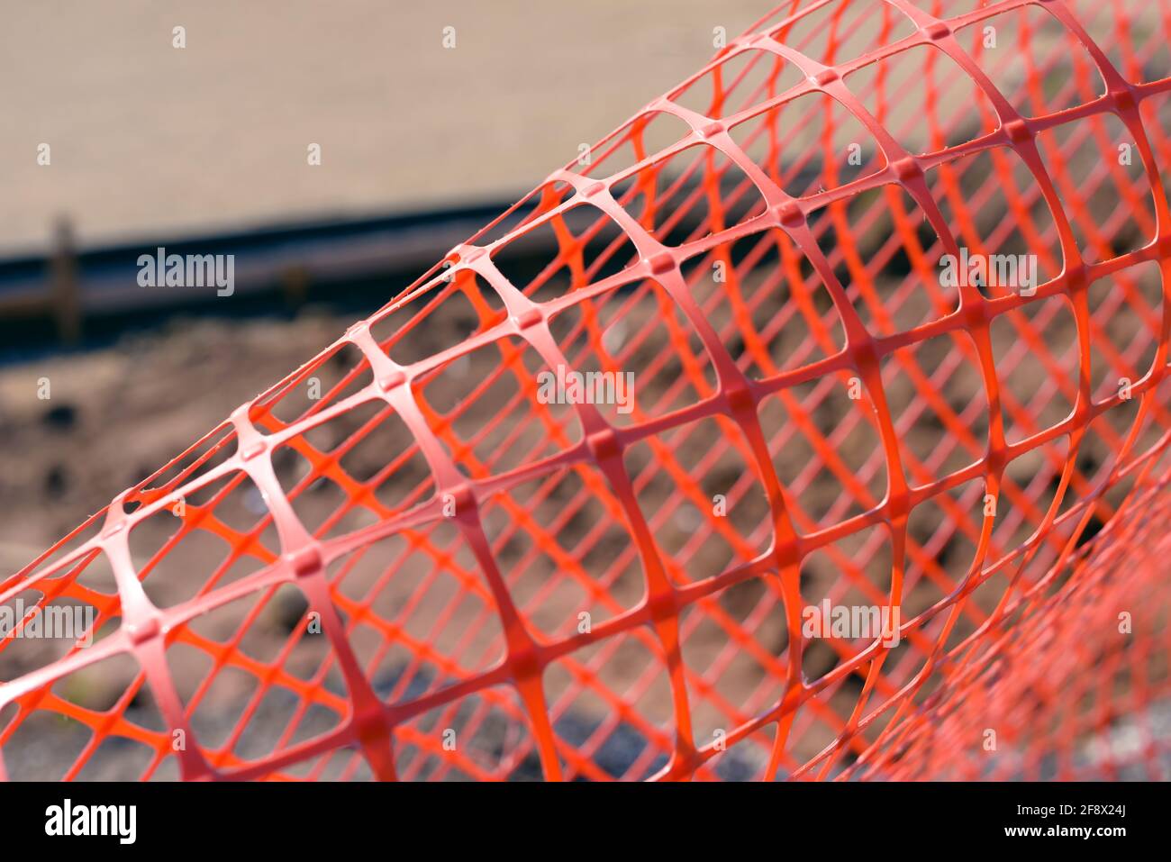 Plastic safety net for construction site. Construction mesh on winter snow background. Stock Photo