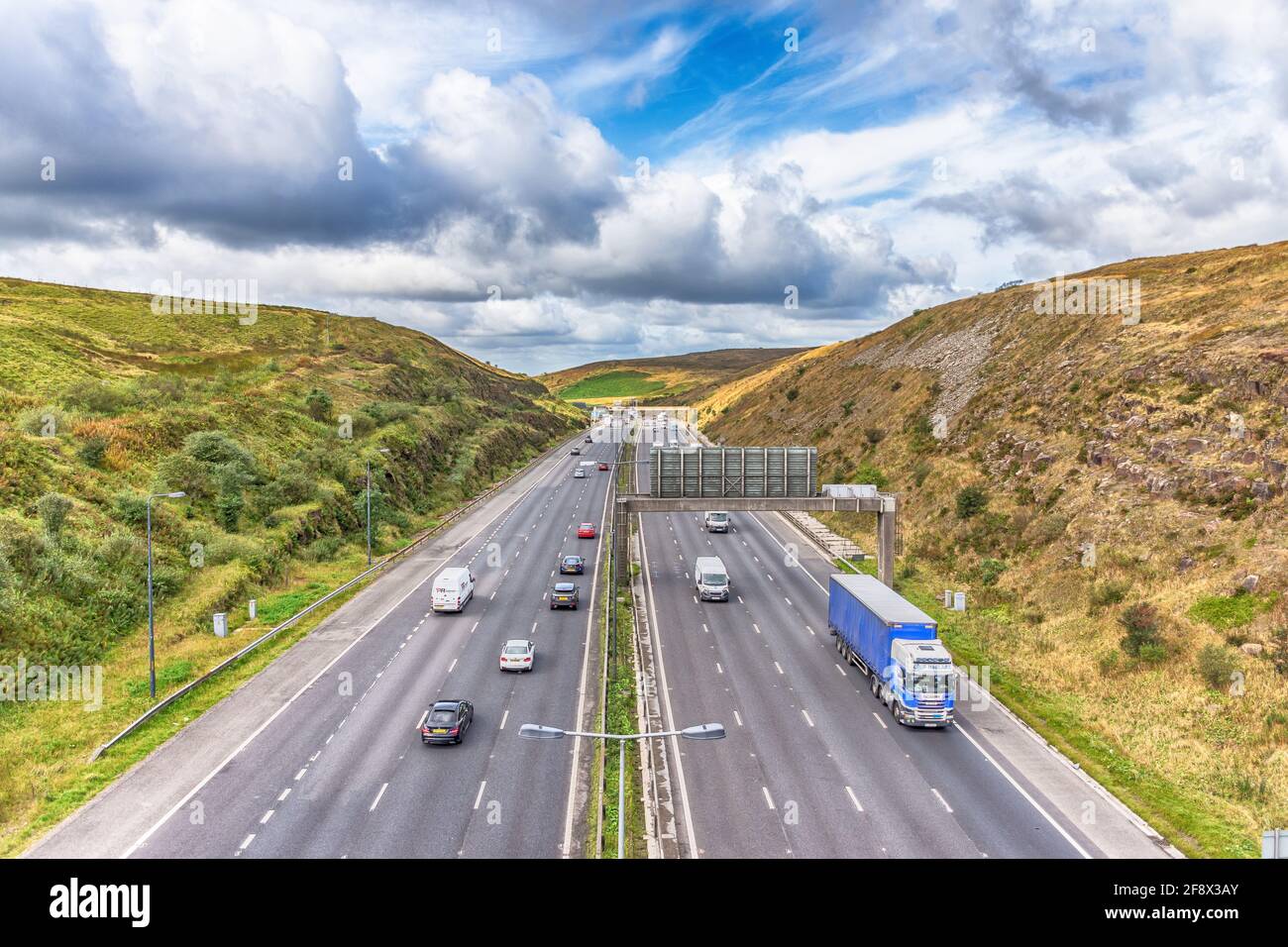 Dramatic view over looking the M62 motorway junction 22 looking west towards Rochdale photograph taken from the Saddleworth Moors Pennine Way Bridge Stock Photo
