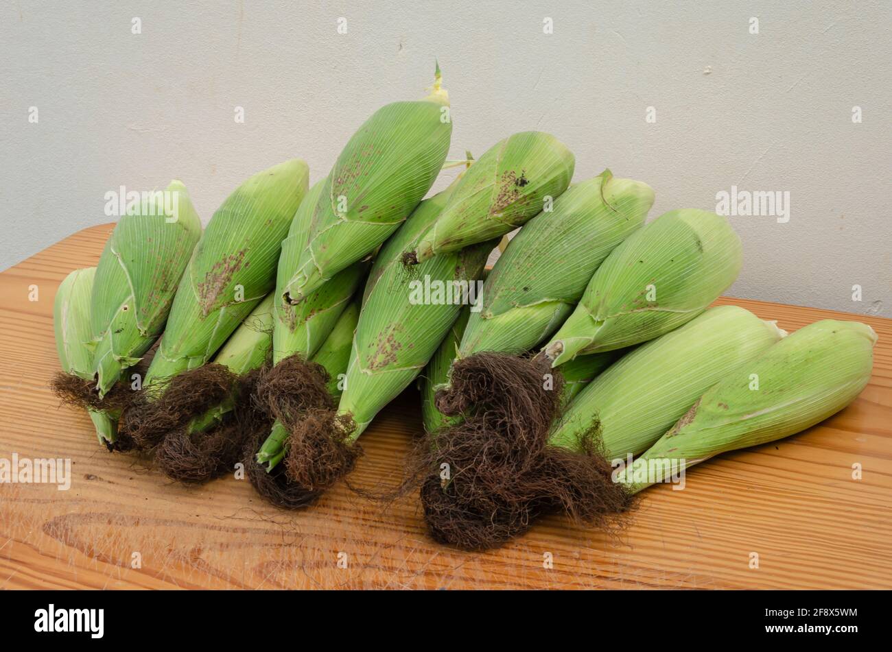 Green Corn On Board Surface Stock Photo