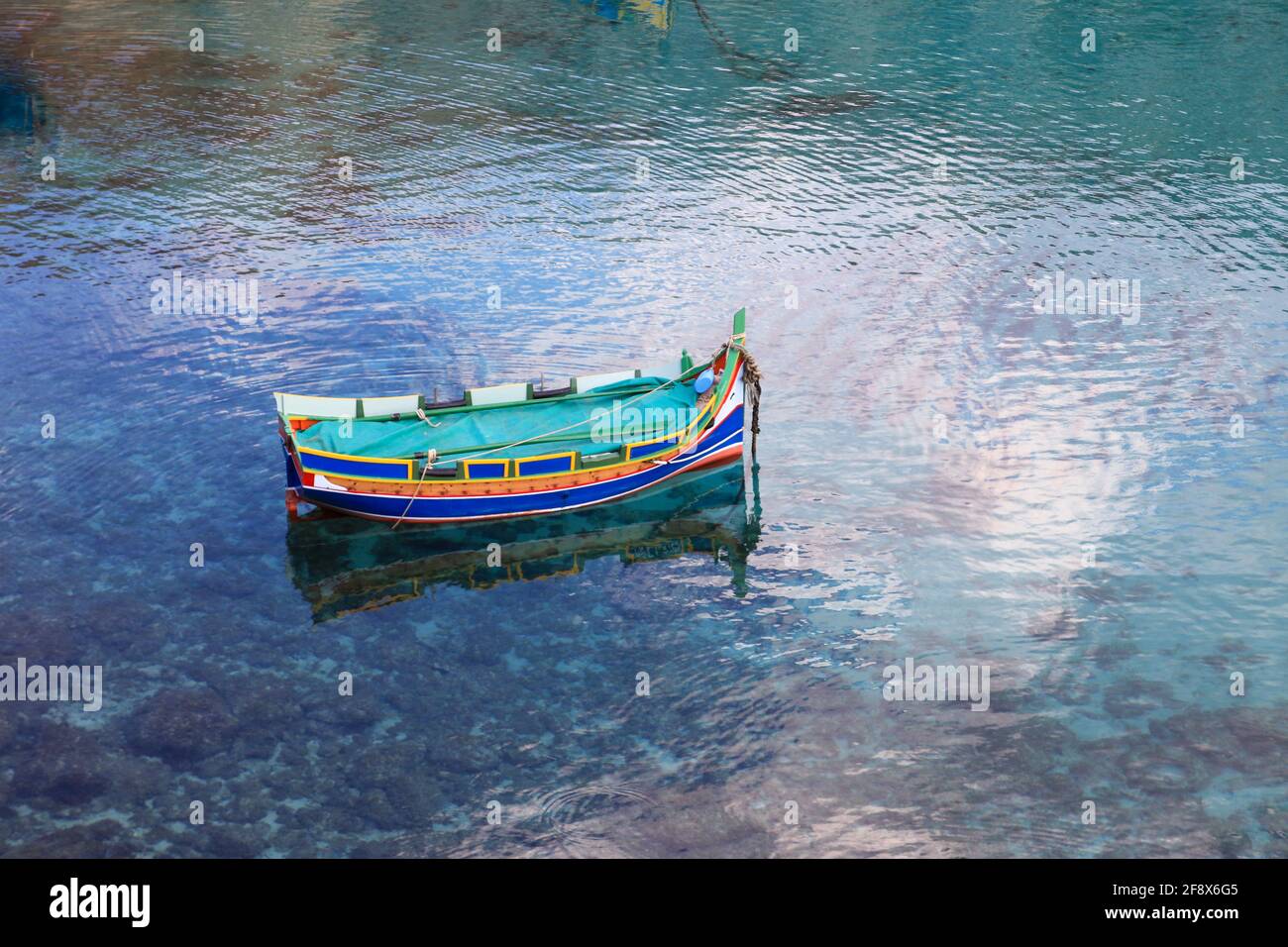 A blue boat located on a turquoise water Stock Photo