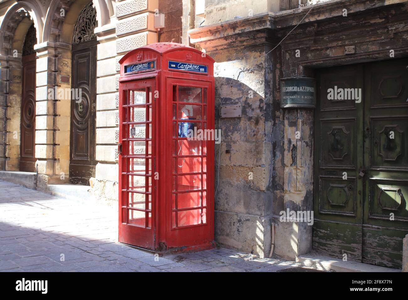Valetta, Malta - October 22, 2020: Famous red telephone booth on the sidewalk in Malta Stock Photo