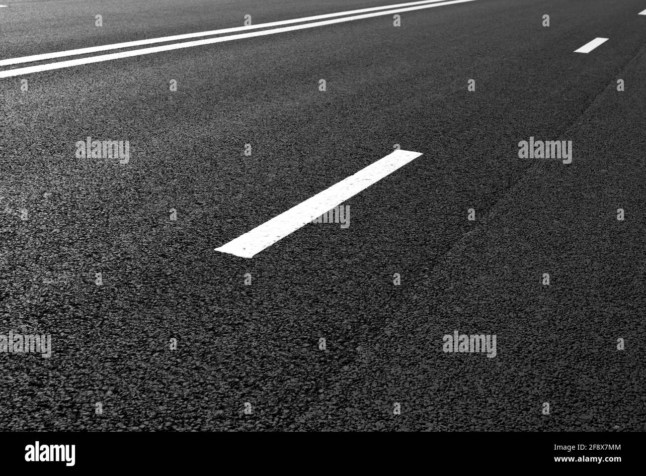 Asphalt road with marking lines white stripes Stock Photo - Alamy