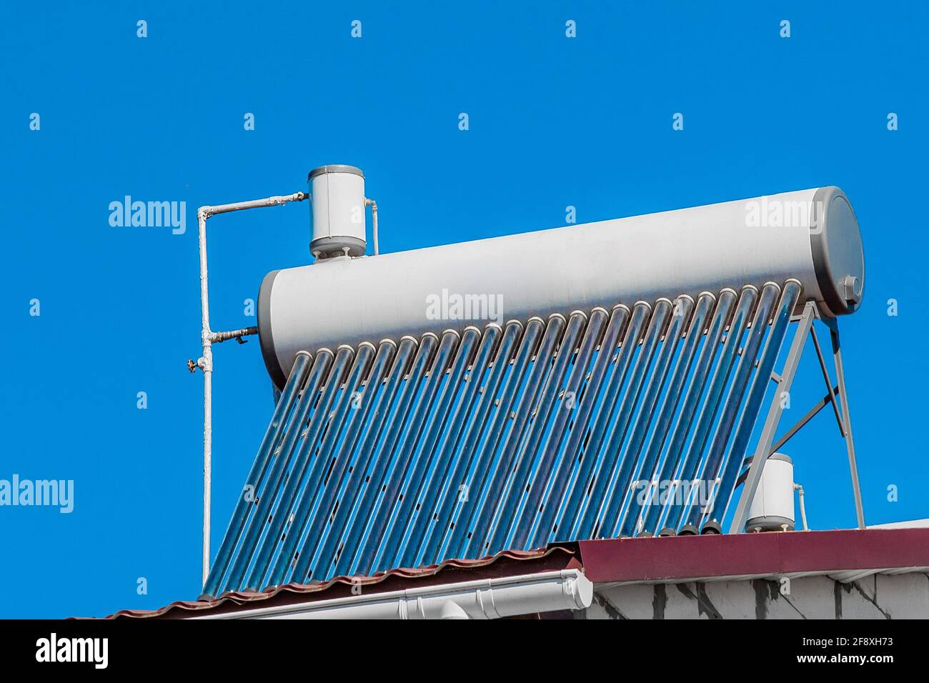 Solar water heater on the roof of a building against the background of ...