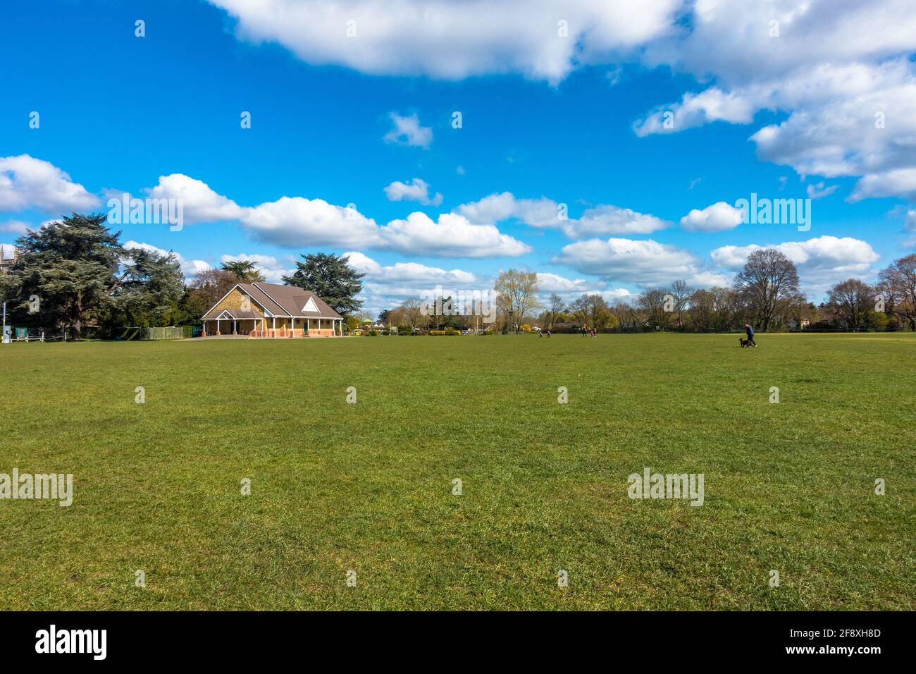 A view of Sol Joel Park, in Earley, Reading, UK. An open green, public space on a day with. blue sky and clouds. Stock Photo