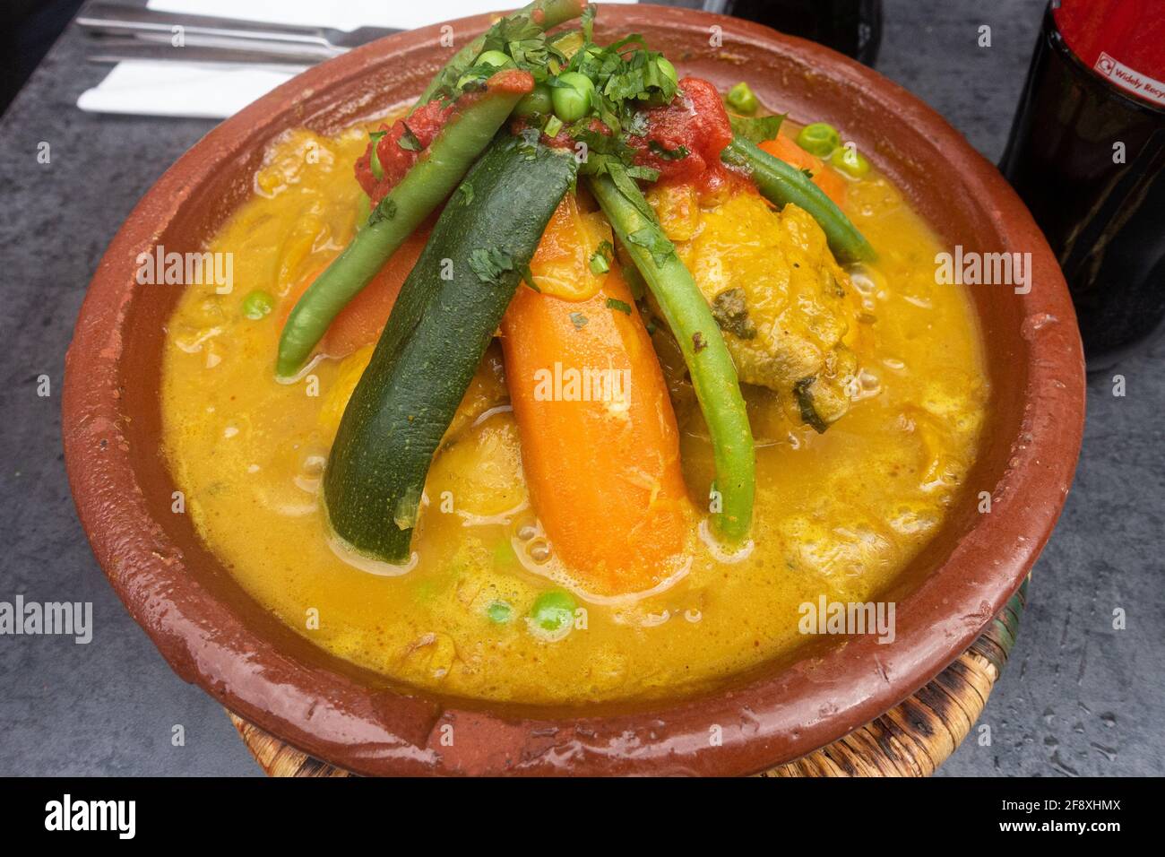 Chicken tagine with vegetables, a Moroccan dish served at a restaurant