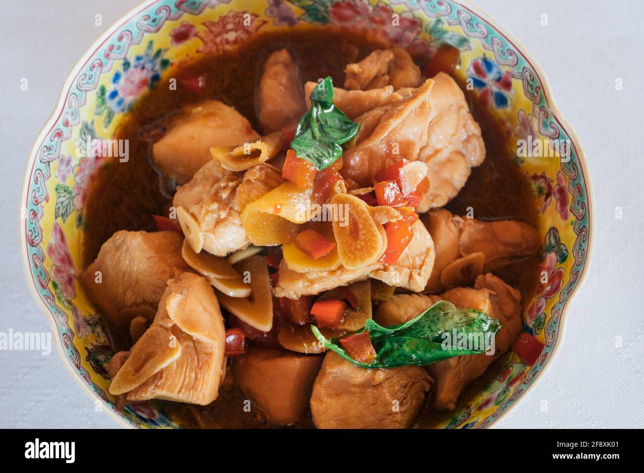 San Bei Ji Three Cup Chicken in a Traditional Chinese Bowl, a Traditional Dish of the Taiwanese Cuisine Close Up Stock Photo