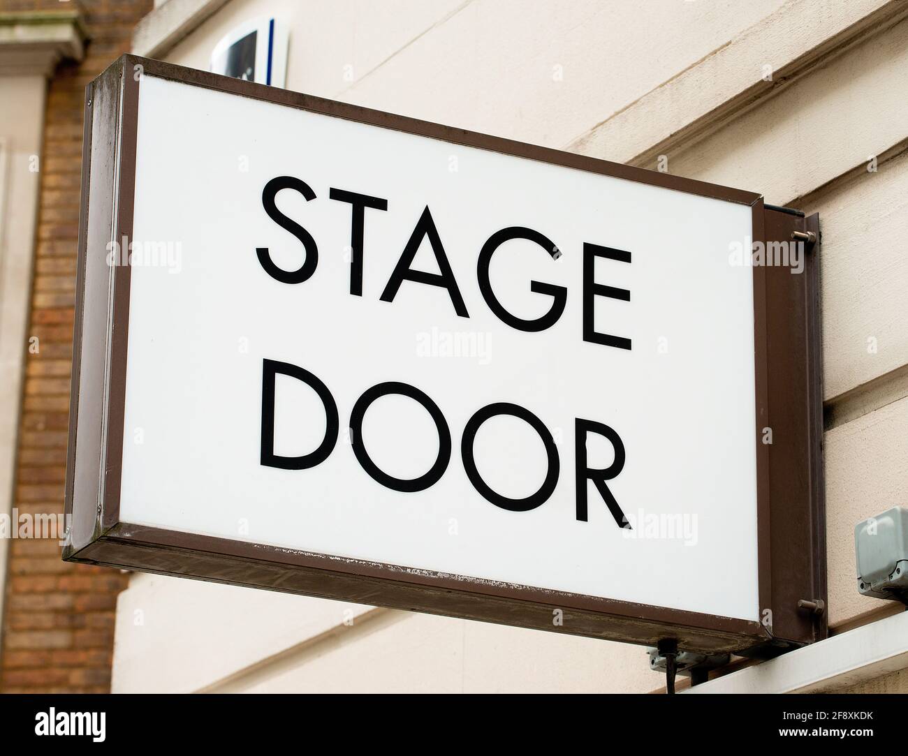 Low angle view of STAGE DOOR sign attached to the exterior wall of theatre in London's West End. Stock Photo
