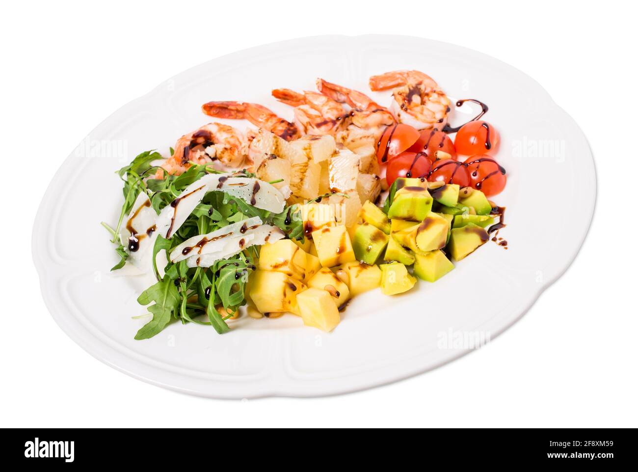 Jumbo shrimp salad with avocado and mango topped with pine nuts and