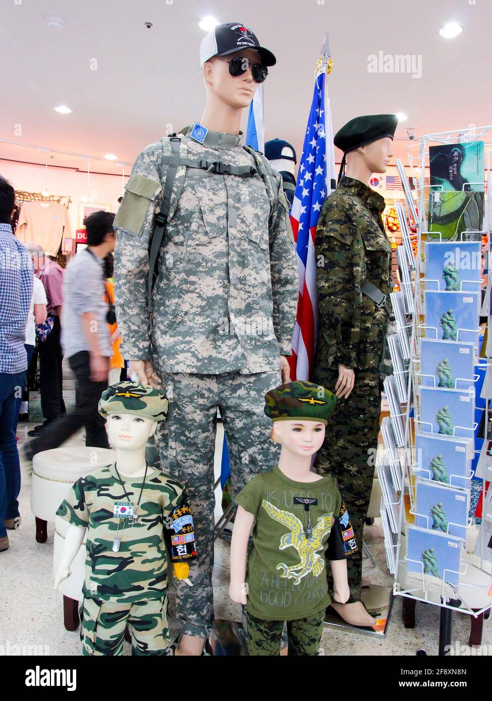 In the gift shop, a display of a man and kids in full camoulflage