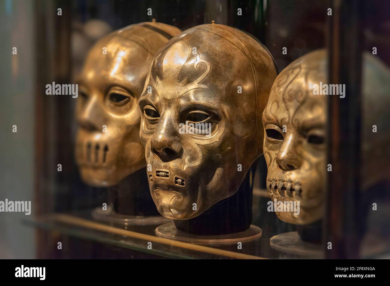 Death Eater Masks in display case at The Making of Harry Potter Studio Tour. Warner Bros. Studios, Leavesden, London UK Stock Photo