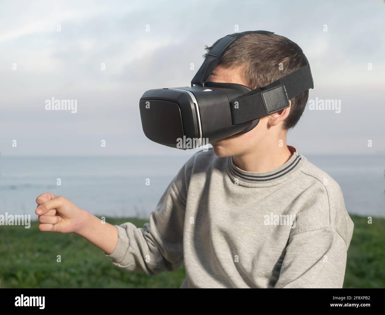 Teenager With Virtual Reality Glasses Playing Outdoor A Virtual Game Stock Photo