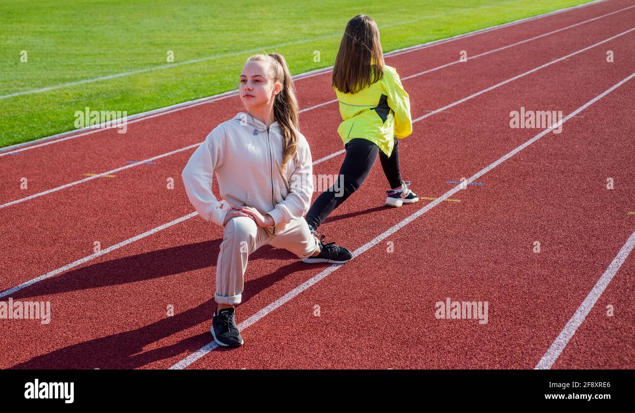 Physical training for children. Fit girls do outward lunging. Physical