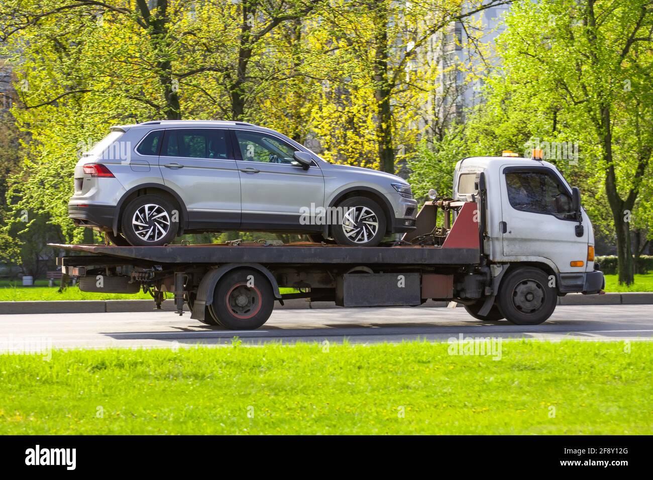 Hatchback car loaded onto a tow truck ready for transport Stock Photo