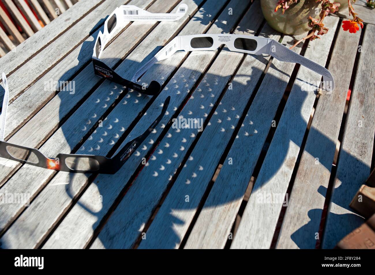 Person holding strainer to view Solar Eclipse of 2017. Stock Photo