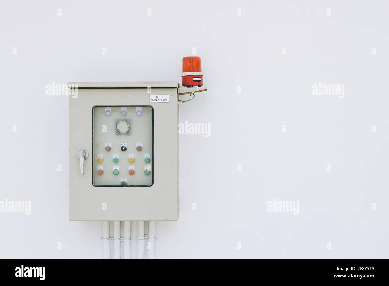 Power box for industry building electricity circuit breakers fuse switch panel with rotating alarm buzzer on white wall Stock Photo