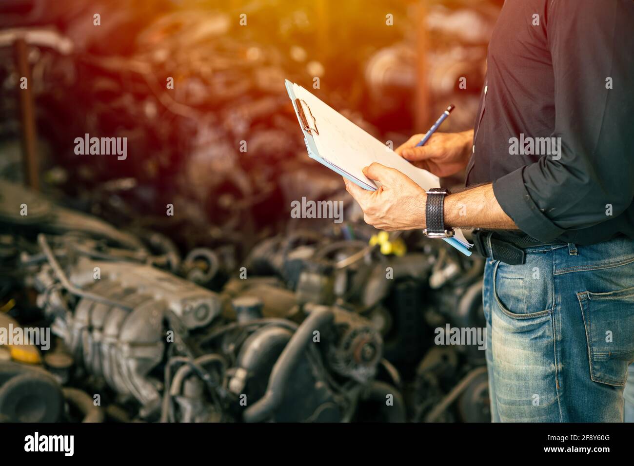 Engineer employee working with manager checking stock inventory in garage used engine car part store Stock Photo