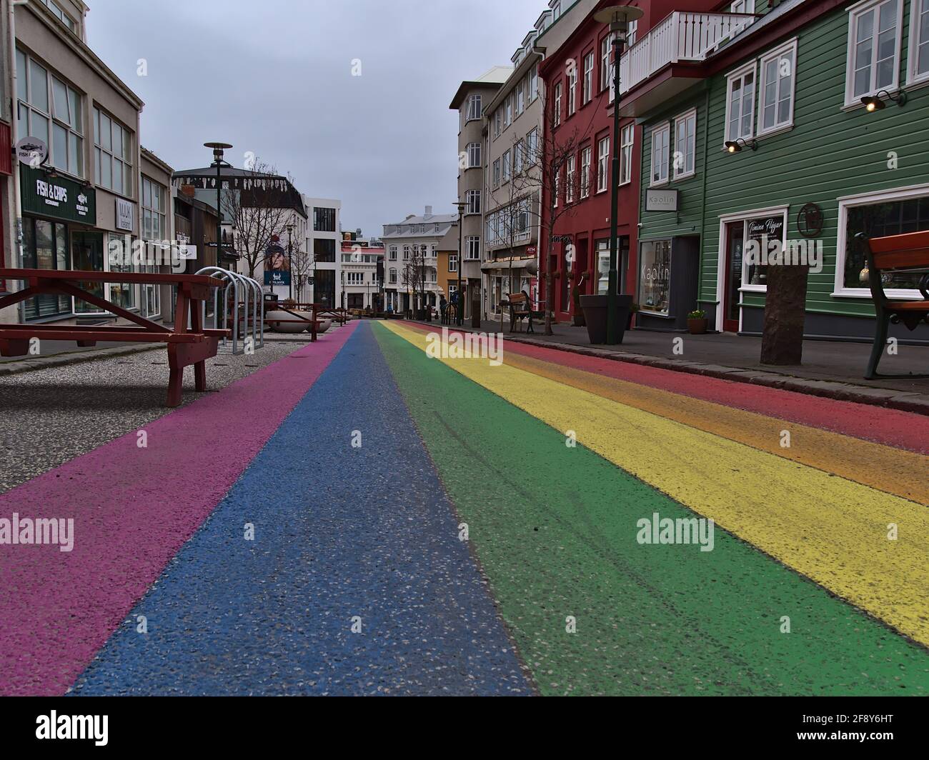 View of empty rainbow road, a shopping street in the center of Reykjavik, dedicated to Reykjavik Pride Gay Festival on cloudy winter day. Stock Photo