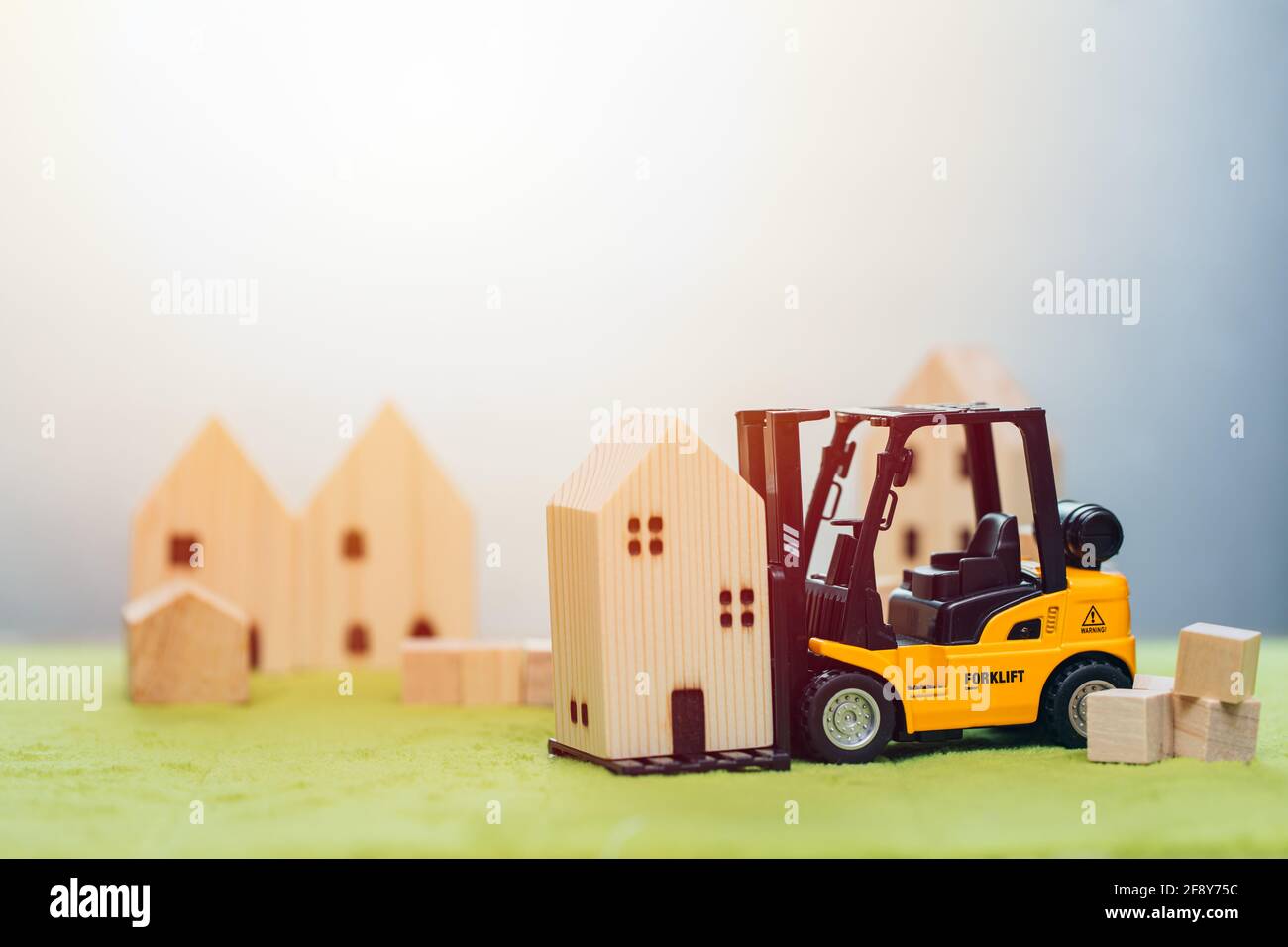 wooden small home model with forklift car for moving house or home building renovation for good