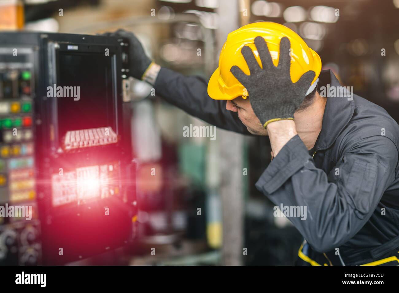 engineer worker inexperienced service man confuse nervous and stressful to fix and operate broken machine problem in factory Stock Photo