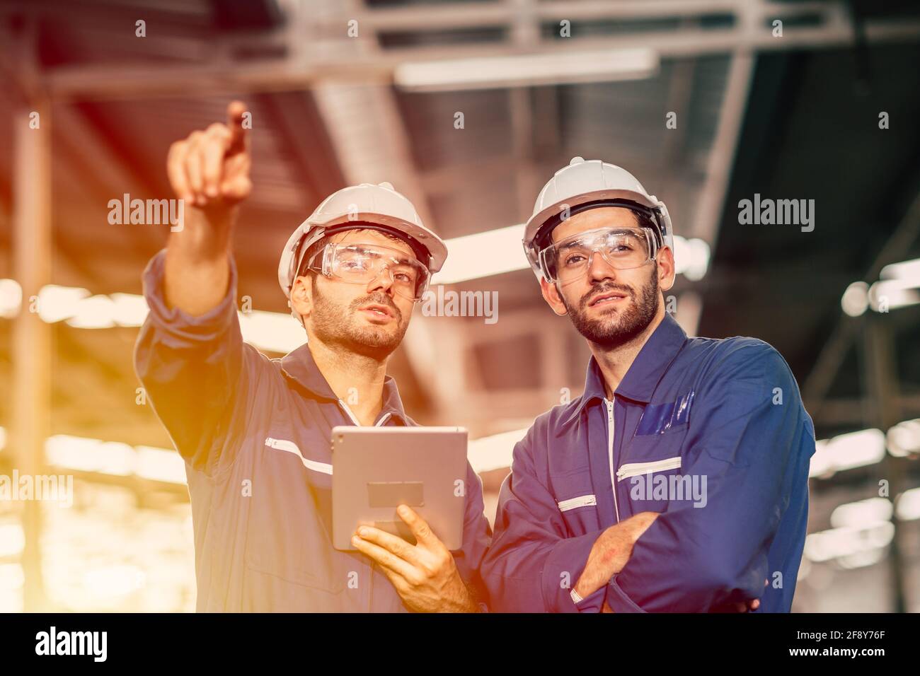 Engineer worker friend people team working discussion help support together at work in heavy industry factory. Stock Photo