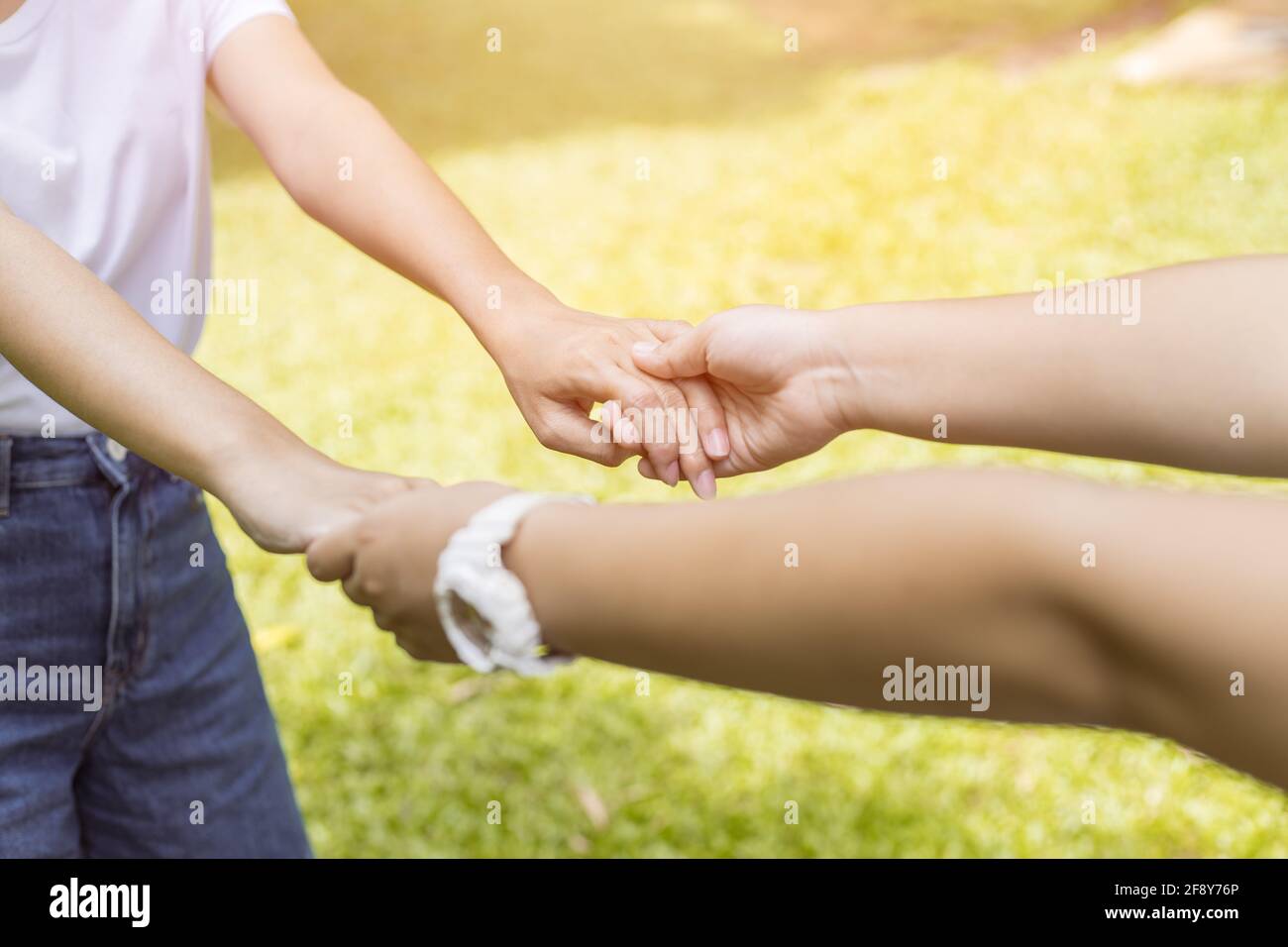 Girl teen Reach her Hand Holding Together to Help Care and Support be a Good Friend with Love concept. Stock Photo
