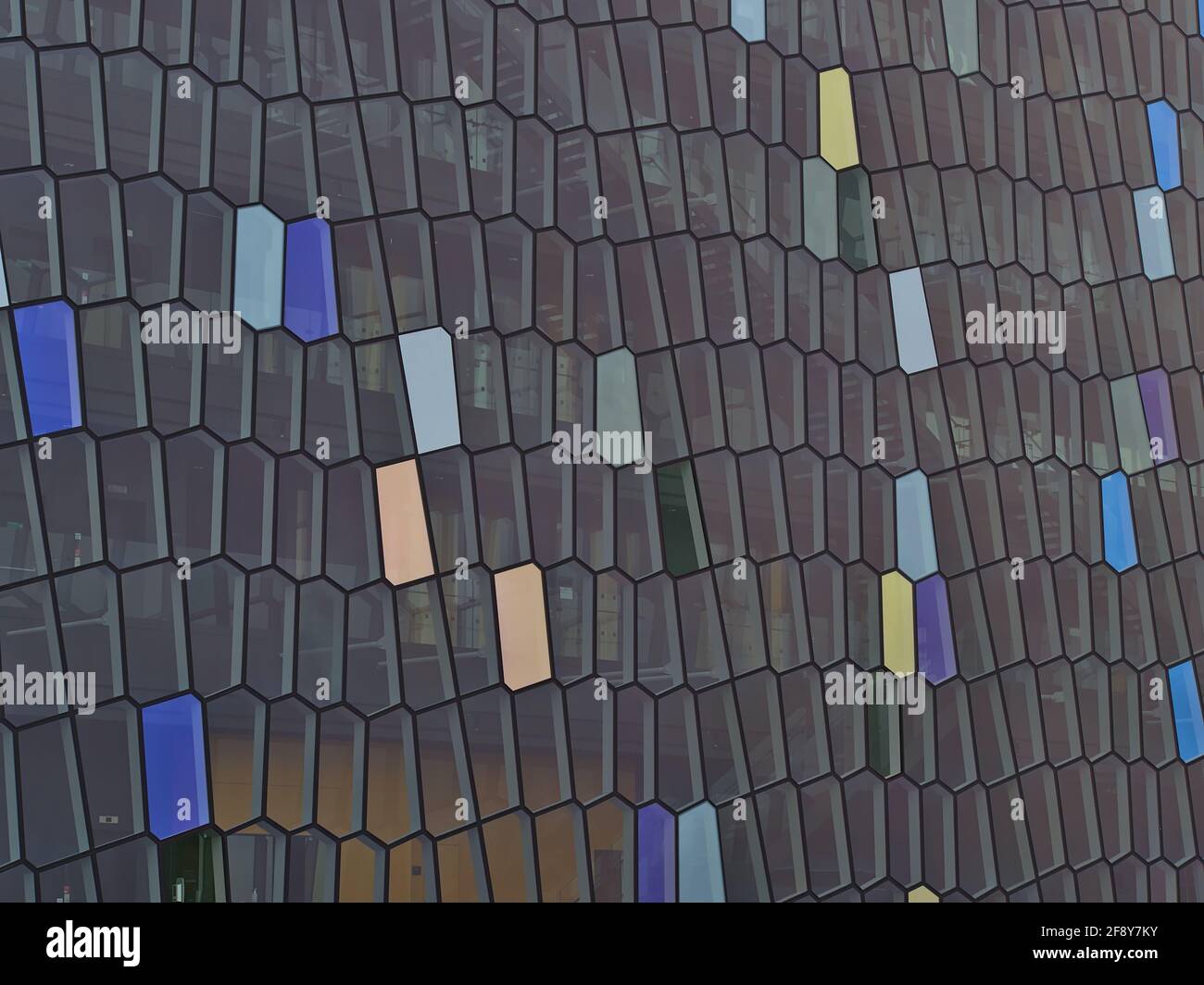 Closeup view of the patterned glass facade of concert hall and conference center Harpa in Reykjavik downtown inspired by Icelandic basalt landscape. Stock Photo