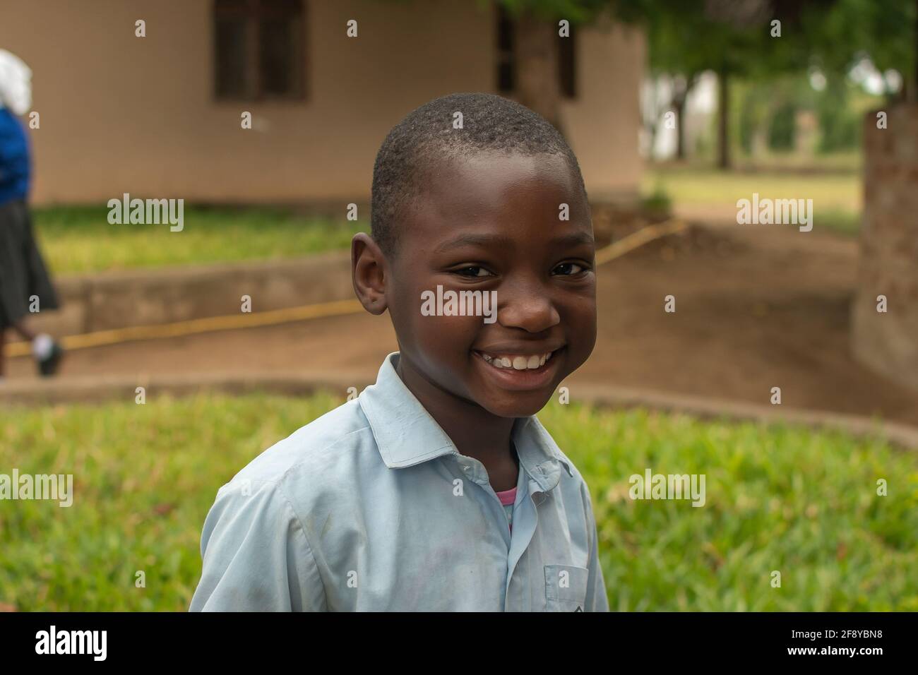Dodoma, Tanzania. 08-18-2019. Portrait of a muslim smiling black boy on a class break during school hours in a remote village in Tanzania. Stock Photo