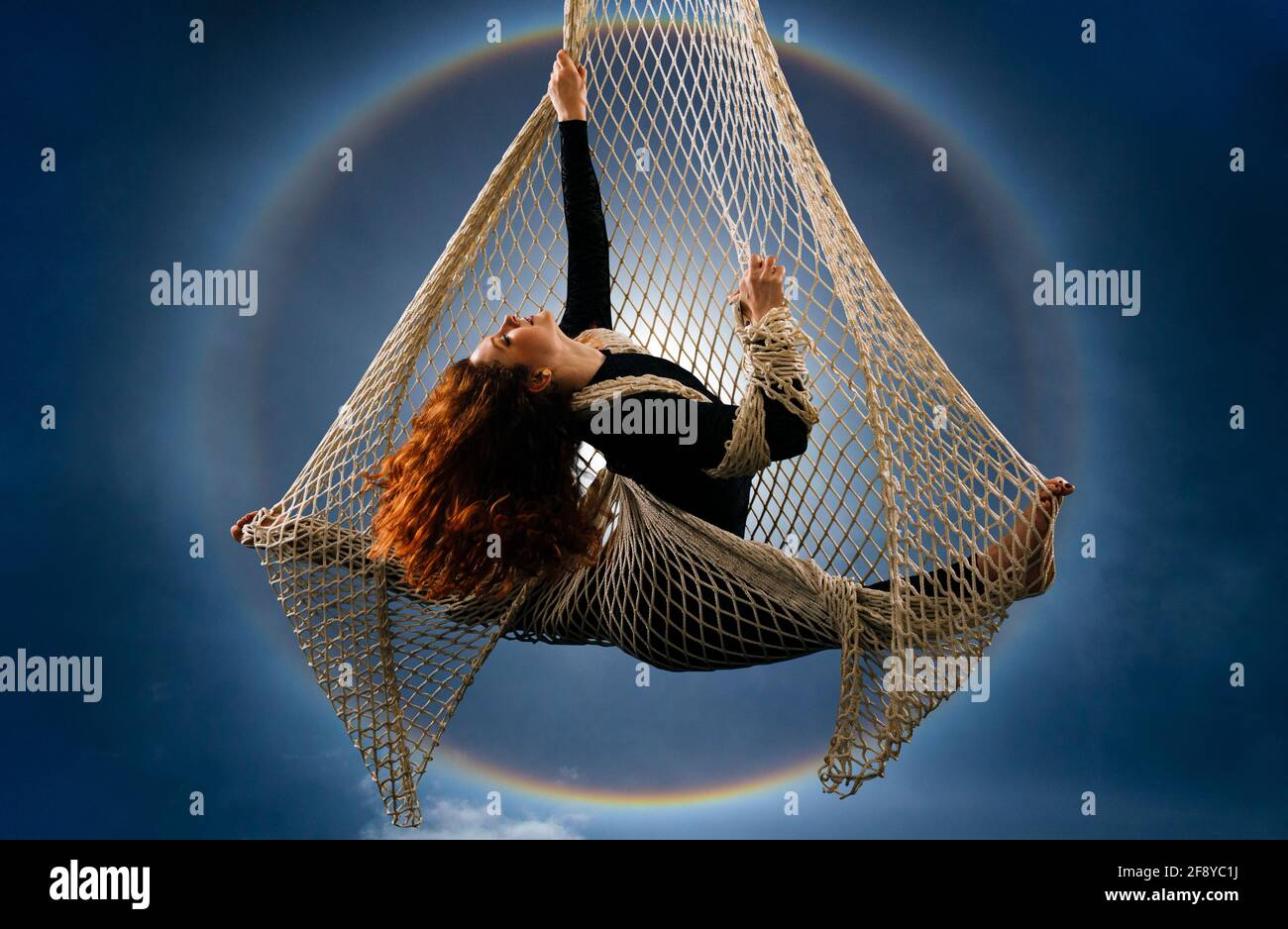 Woman dancing with grace as aerialist Stock Photo