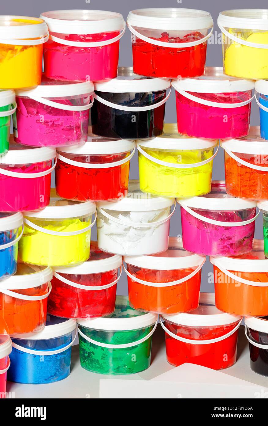 Screen printing inks in a variety of vibrant colors are stacked in