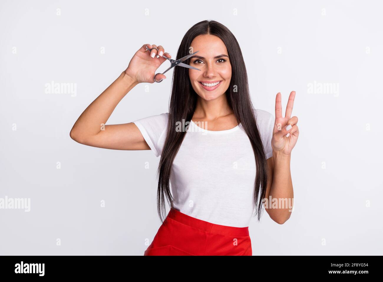 Photo of nice optimistic brunette long hairdo lady with scissors show v ...
