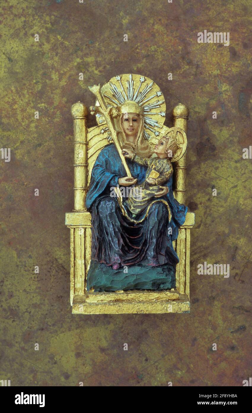 Model of Virgin Mary sitting on gold throne with sceptre and baby Jesus on her lap Stock Photo