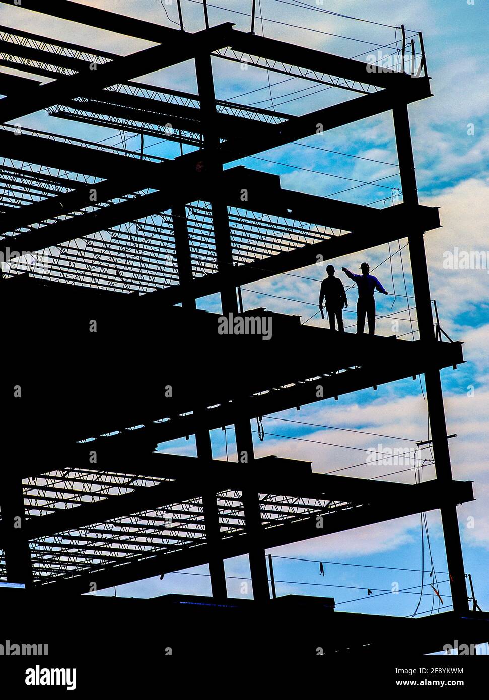 Silhouette of workers on metal building scaffolding, Chicago, Illinois, USA Stock Photo