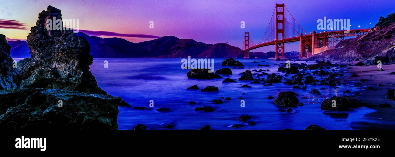 Scenics view of shore at dusk with ridge and Golden Gate Bridge in background, San Francisco, California, USA Stock Photo