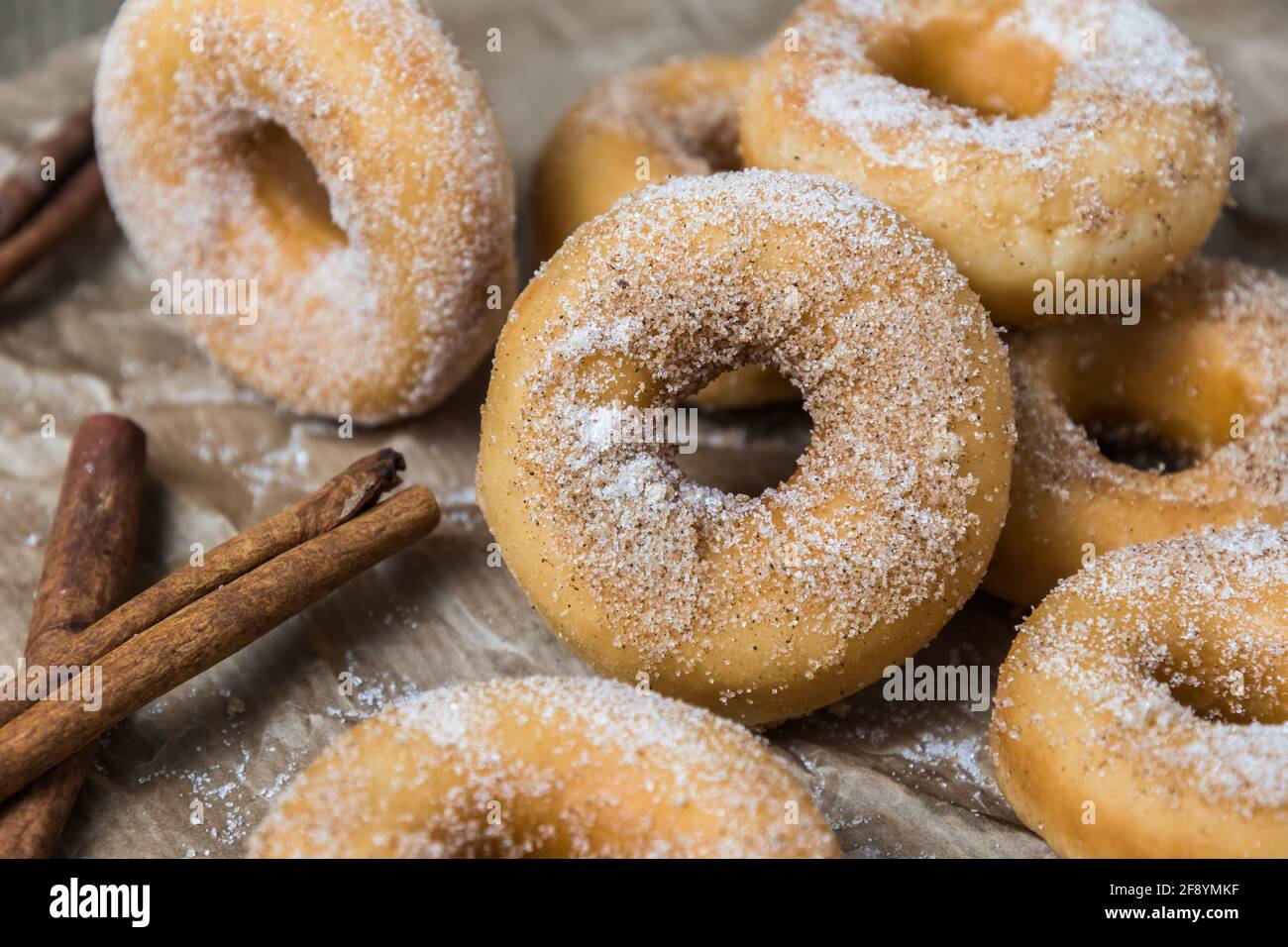 Closeup of mini donuts with sugar and cinnamon on a brown paper Stock Photo