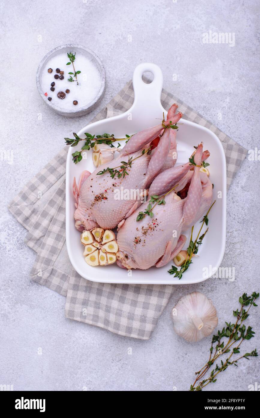 Raw quail meat with spices, garlic and herbs Stock Photo Alamy