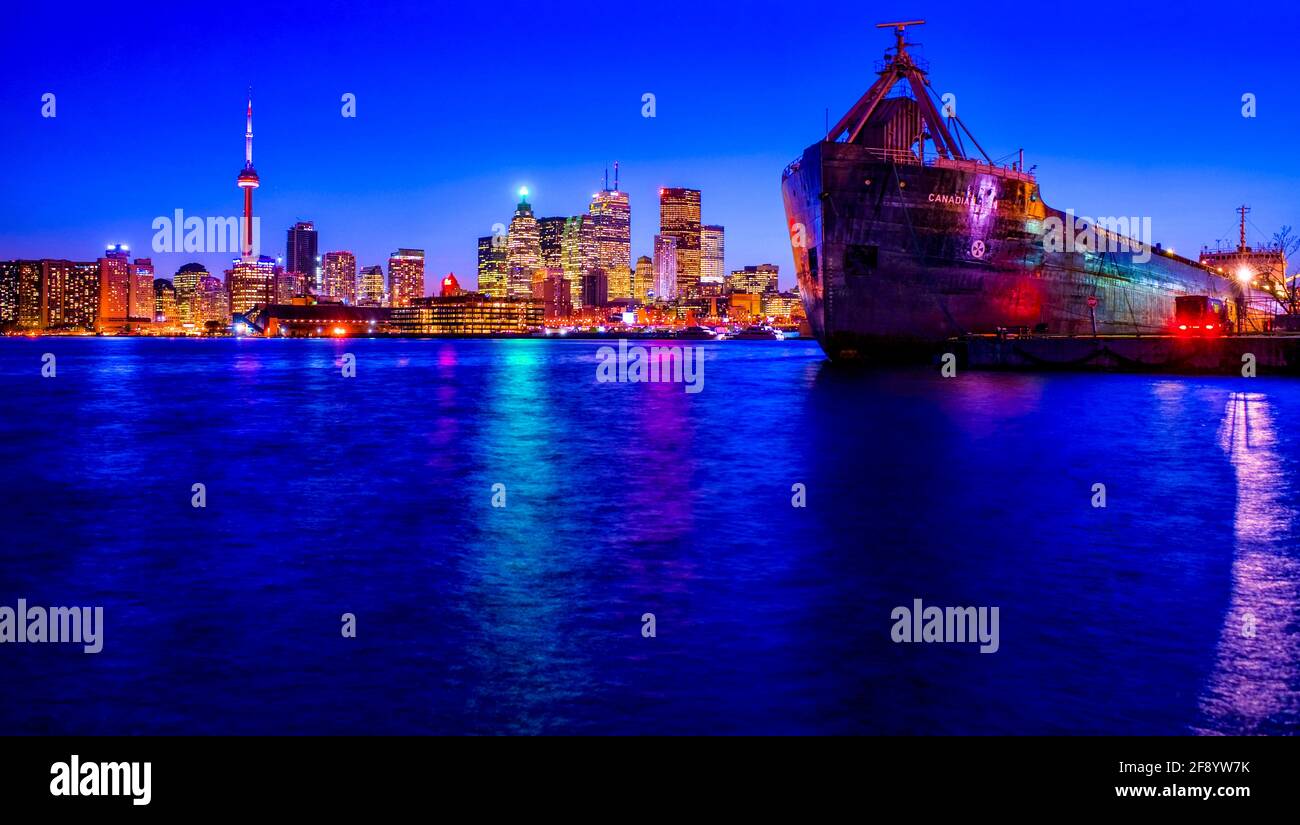 Skyline at night on shore of Lake Ontario and container ship, Toronto, Ontario, Canada Stock Photo