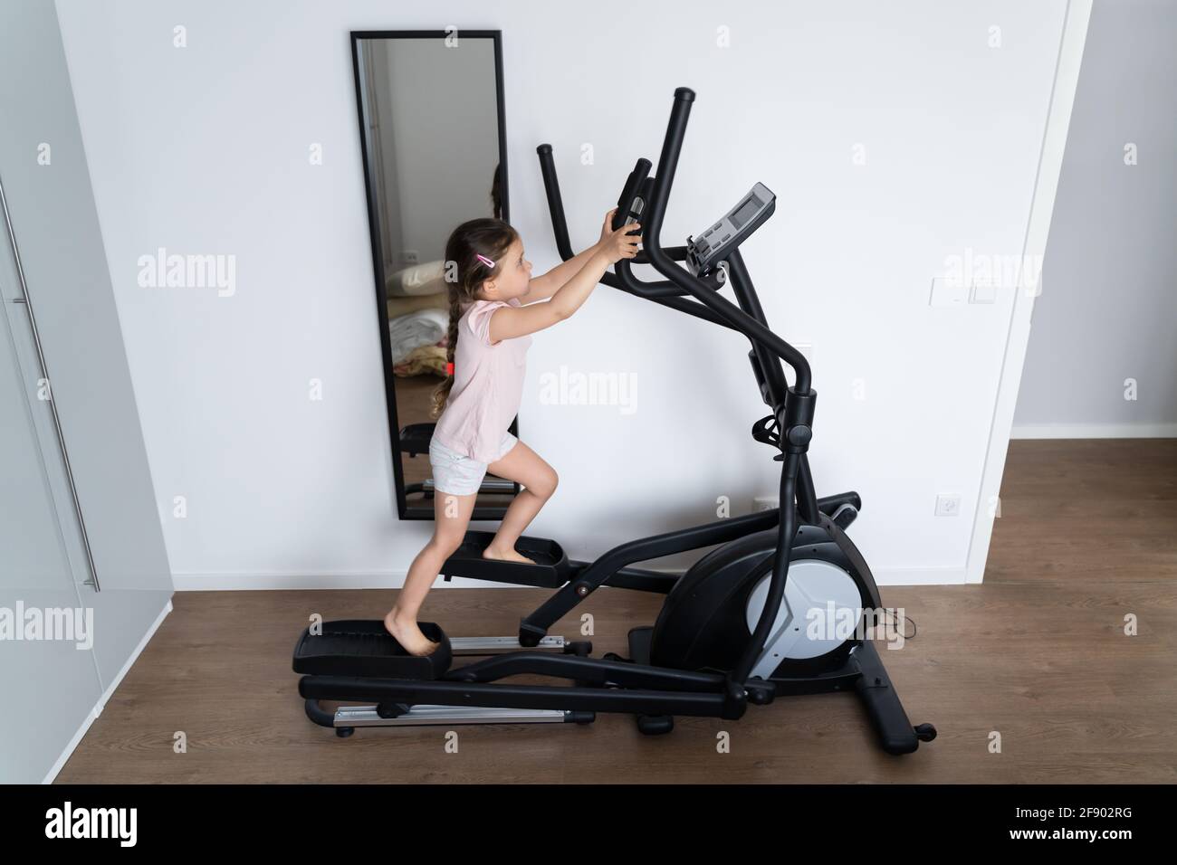 Kid Child Training On Elliptical Cross Trainer Stock Photo