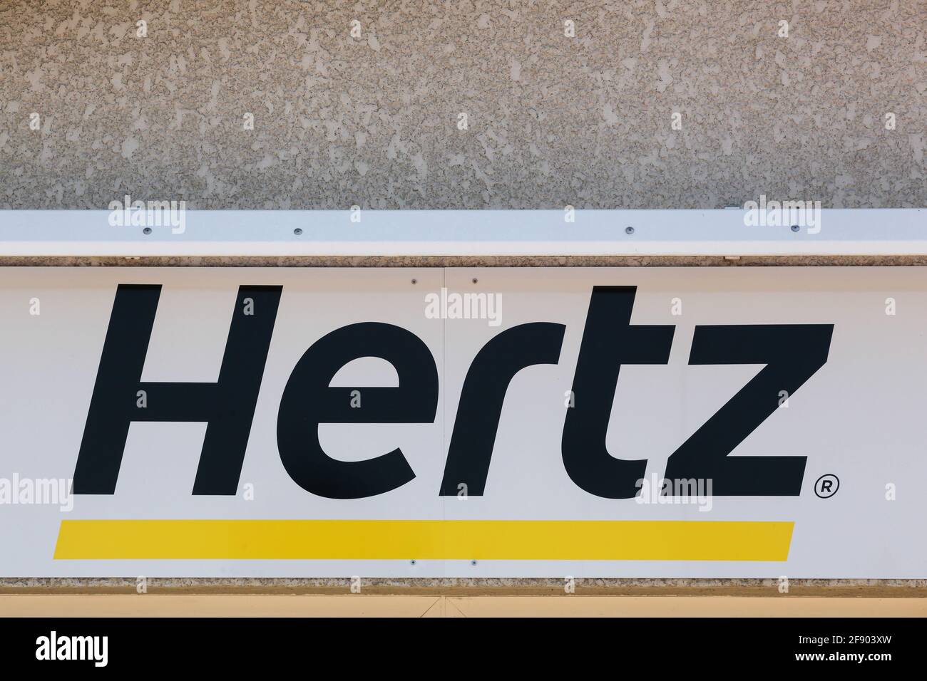 Roanne, France - May 31, 2020: Hertz logo on a wall. Hertz is an American car rental company with international locations in 145 countries worldwide Stock Photo