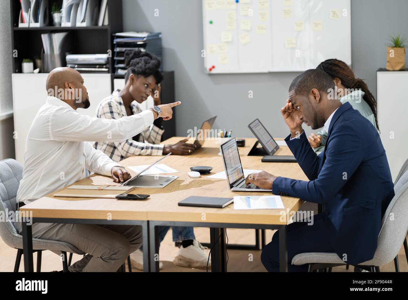 Angry Office Business Meeting Argument. African Group Arguing And Fighting Stock Photo