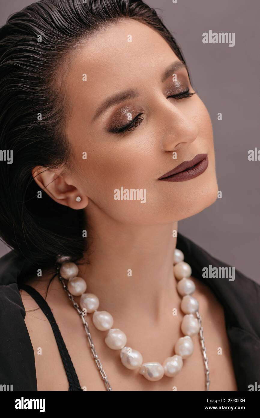 Portrait of a beautiful woman wearing a pearl necklace Stock Photo