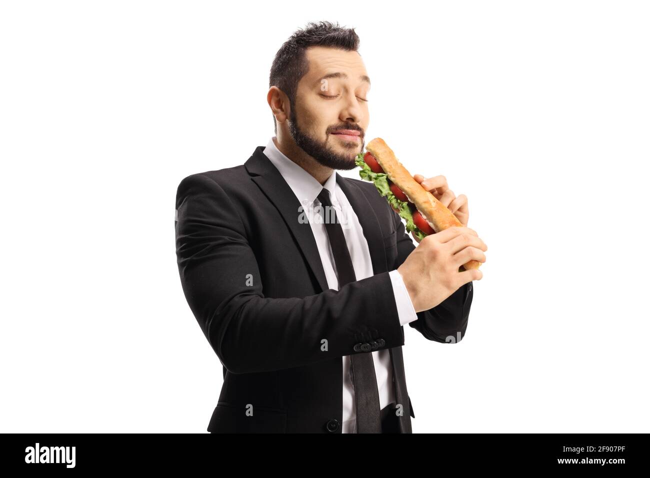Businessman eating a sandwich in a baguette and enjoying isolated on white background Stock Photo