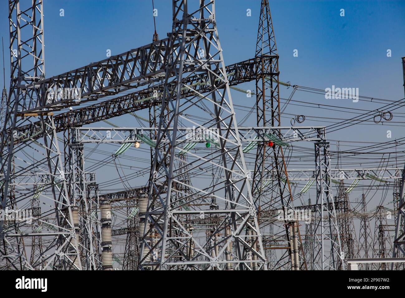 Close-up view of electric transformer substation. Distribution station of electricity. Blue sky background. Stock Photo