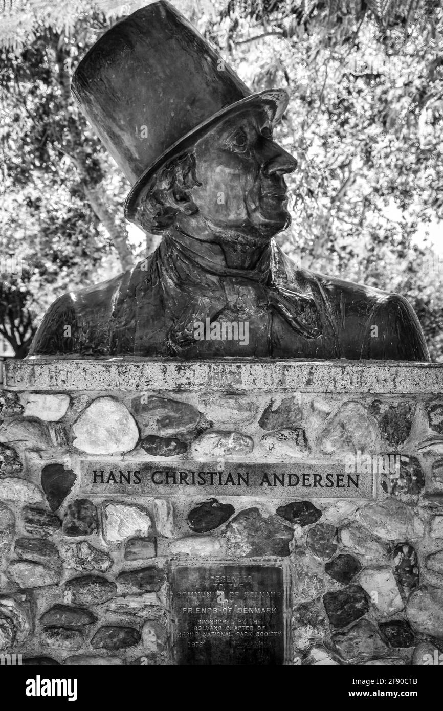 A sculptural bust of Hans Christen Andersen wearing a top hat at a namesake Park with dedication plaque in the Danish Village of Solvang, CA Stock Photo