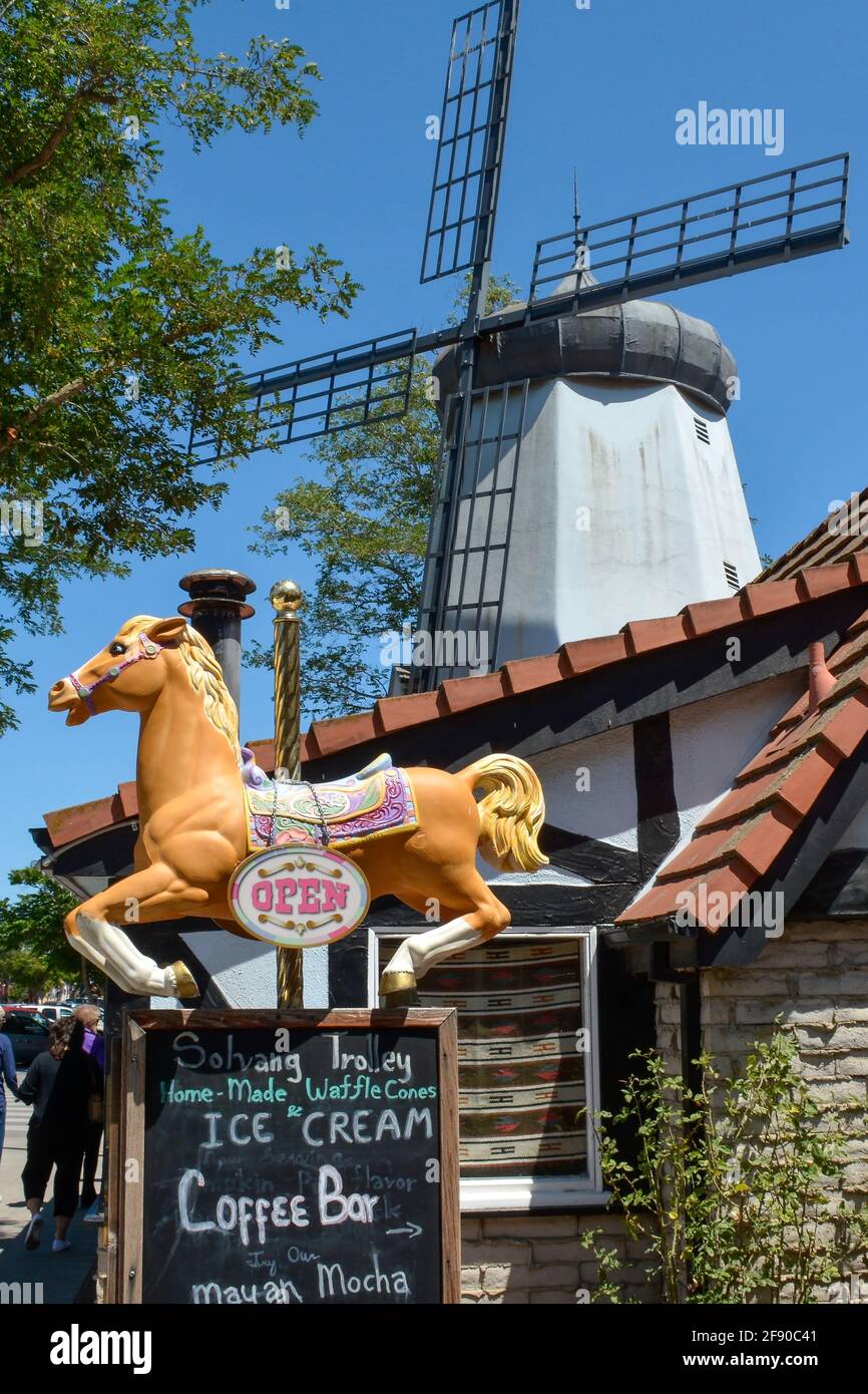 An iconic windmill overlooks Hamlet Square with shops and carousel ...